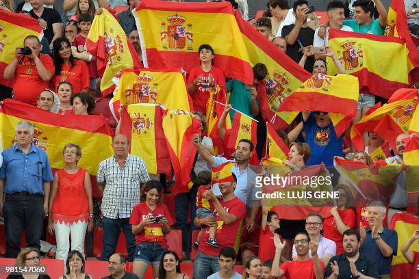 Spanish supporters wave Spanish flags during the opening ceremony of the XVIII Mediterranean Games in Tarragona, on June 22, 2018.