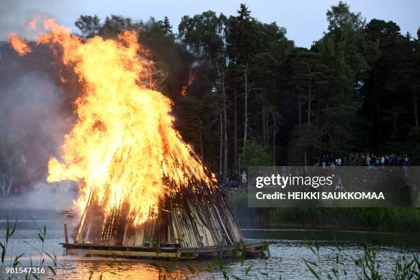 Bonfire is lit up to celebrate the summer solstice during the Seurasaari openair museum's Midsummer Eve festival in Helsinki, Finland on June 22,...