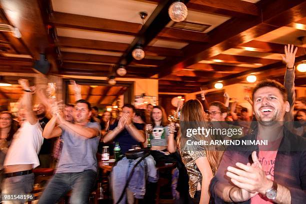 Kosovo Albanian supporters of Switzerland celebrate the goal of Granit Xhaka as they watch a telecast in a pub in Pristina on June 22 of the World...