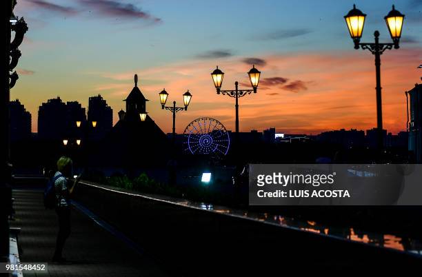 Tourist visits the Kremlin in Kazan on June 22, 2018 at sunset, during the Russia 2018 World Cup football tournament.