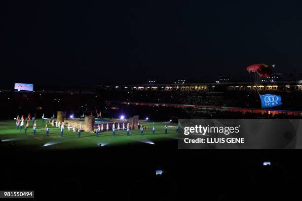 Parachutist prepares to land as he carries the Mediterranean Games flag, during lthe opening ceremony of the XVIII Mediterranean Games in Tarragona,...