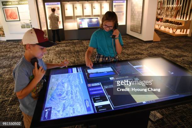 Harrison Grant of Arvada, left, and his sister Bella right, are checking the ski resort interactive table at the Colorado Ski and Snowboard Museum....