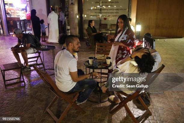 Young Saudis chat outside Medd Cafe and Roastery, a popular hangout where Saudi men and women mix together freely, on June 21, 2018 in Jeddah, Saudi...