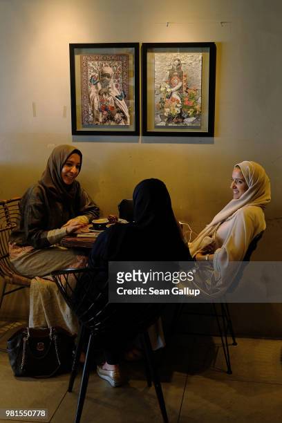 Cousins Heba Hariri, Duaa Hamadah and Asmaa Hamadah chat at Medd Cafe and Roastery, a popular hangout for creative Saudis, on June 21, 2018 in...