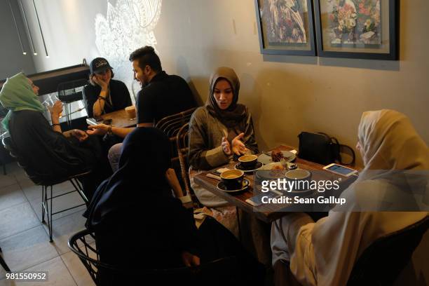 Heba Hariri chats with her cousins Duaa Hamadah and Asmaa Hamadah at Medd Cafe and Roastery, a popular hangout where young Saudi men and women mix...