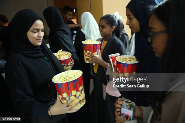 Young Saudi female teenage friends purchase popcorn during their first outing ever to a cinema in Saudi Arabia to watch "The Incredibles 2" at the...