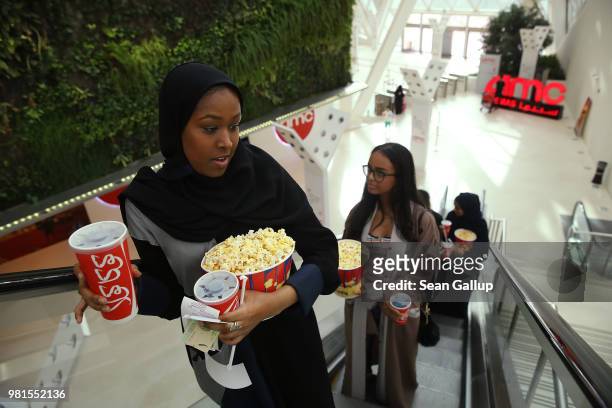 Friends Lujane Samia and others clutch popcorn and Cokes in their first outing ever to a cinema in Saudi Arabia to watch "The Incredibles 2" at the...