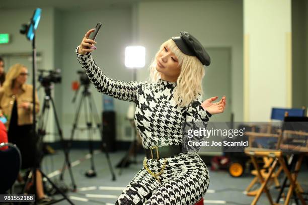 Nikita Dragun uses her cellphone backstage at the 9th Annual VidCon at Anaheim Convention Center on June 22, 2018 in Anaheim, California.