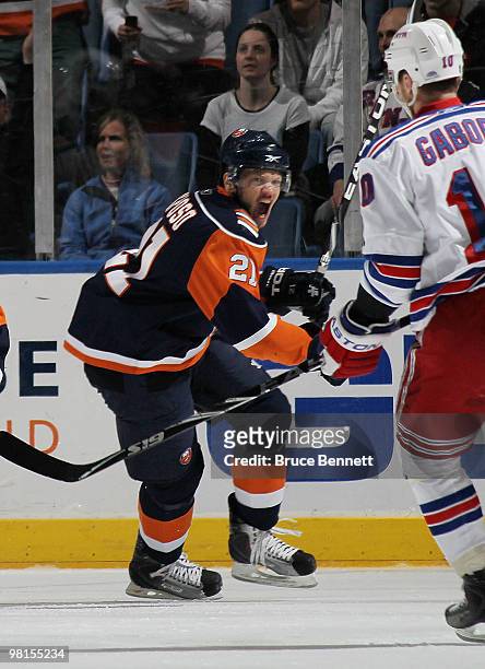 Kyle Okposo of the New York Islanders celebrates a first-period goal by Mark Streit against the New York Rangers at the Nassau Coliseum on March 30,...