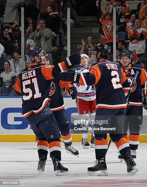 Frans Nielsen of the New York Islanders celebrates a first period goal by Mark Streit against the New York Rangers at the Nassau Coliseum on March...