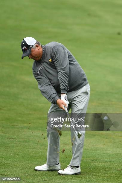 Kenny Perry hits his approach shot on the 18th hole during the first round of the American Family Insurance Championship at University Ridge Golf...