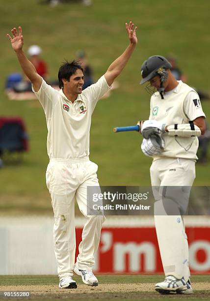 Mitchell Johnson of Australia celebrates his 6th wicket of Tim Southee of New Zealand to win the match as Chris Martin looks on during day five of...