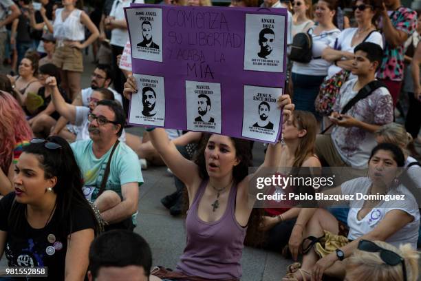 Protester holds a placard with pictures depicting the wolf pack members and reading 'Their freedom starts, but mine finishes' during a demonstration...