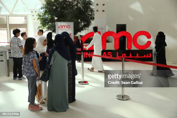 Movie goers arrive to watch "The Incredibles 2" at the newly-opened AMC Cinema in the King Abdullah Financial District on June 20, 2018 in Riyadh,...
