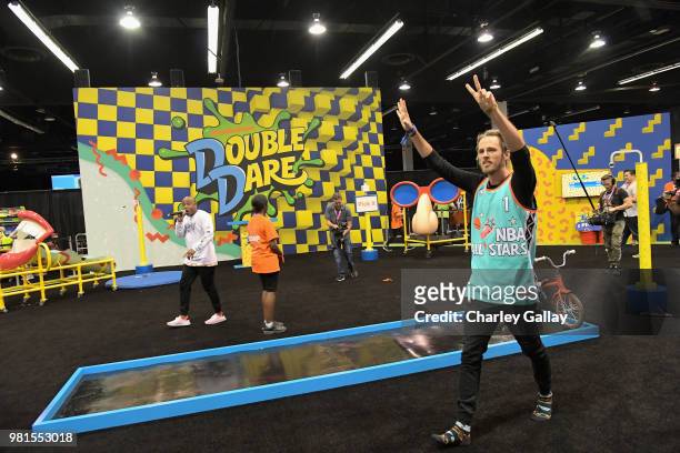 Youtube personality David Moore experiences the Double Dare obstacle course at Nickelodeon's booth at 2018 VidCon at Anaheim Convention Center on...