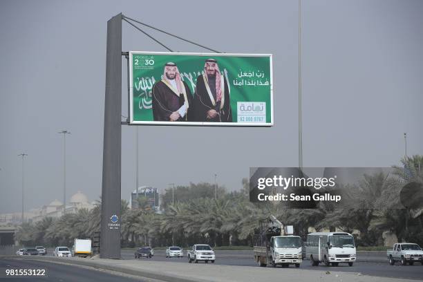 Billboard shows Saudi King Salman bin Abdulaziz and Saudi Crown Prince Mohammad Bin Salman hanging over a highway on June 20, 2018 in Riyadh, Saudi...