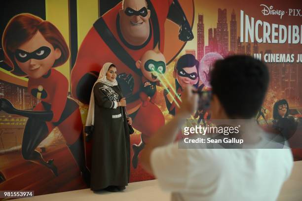 Family member photographs Wahfa after they saw "The Incredibles 2" on their first outing ever to a cinema in Saudi Arabia at the newly-opened AMC...