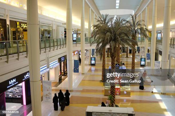 Women wearing the traditional niqab and abaya stroll through a shopping mall on June 20, 2018 in Riyadh, Saudi Arabia. The Saudi government, under...