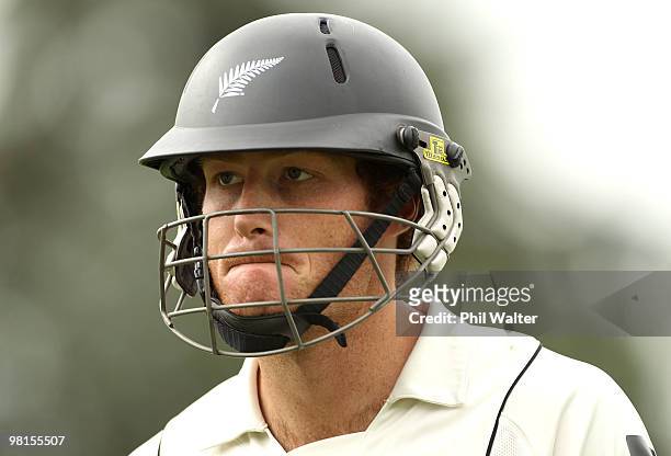 Martin Guptill of New Zealand leaves the field after being caught out by Ricky Ponting of Australia off the bowling of Mitchell Johnson during day...