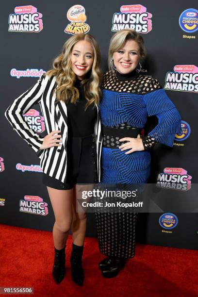 Maddie Ziegler and Kelly Clarkson attend the 2018 Radio Disney Music Awards at Loews Hollywood Hotel on June 22, 2018 in Hollywood, California.