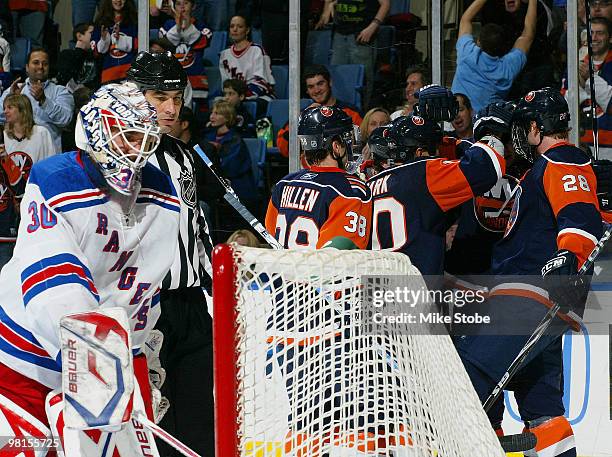 Blake Comeau of the New York Islanders is congratulated by teammates on his first-period goal at 12:09 against goaltender Henrik Lundqvist of the New...