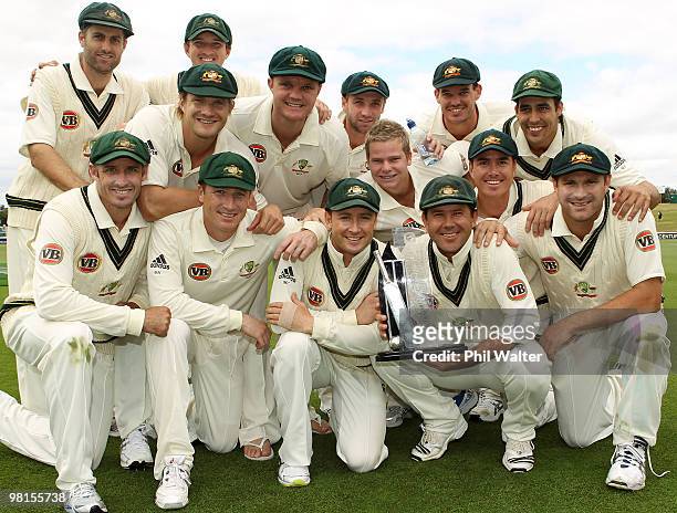 The Australian cricket team pose with the winners trophy following day five of the Second Test match between New Zealand and Australia at Seddon Park...