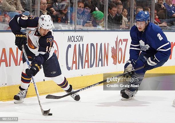 Luke Schenn of the Toronto Maple Leafs battles for the puck with Marty Reasoner of the Atlanta Thrashers during game action March 30, 2010 at the Air...