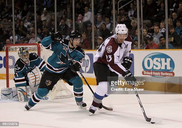 Logan Couture of the San Jose Sharks defends Milan Hejduk of the Colorado Avalanche at HP Pavilion on March 28, 2010 in San Jose, California.