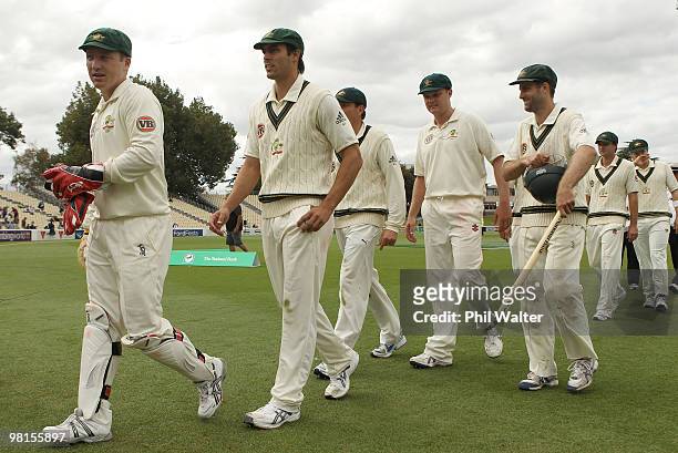 Mitchell Johnson of Australia walks off the pitch with the Australian team after taking his 6th wicket of Tim Southee of New Zealand to win the match...