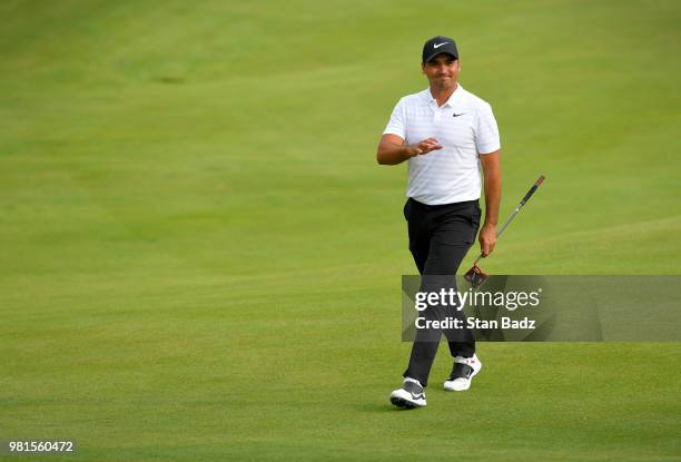 Jason Day of Australia acknowledges the gallery walking along the 18th hole during the second round of the Travelers Championship at TPC River...