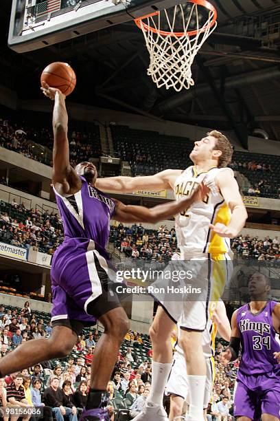 Tyreke Evans of the Sacramento Kings shoots over Josh McRoberts of the Indiana Pacers Conseco Fieldhouse on March 30, 2010 in Indianapolis, Indiana....