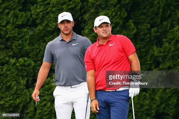 Brooks Koepka and Patrick Reed of the United States stand on the 9th tee during the second round of the Travelers Championship at TPC River Highlands...