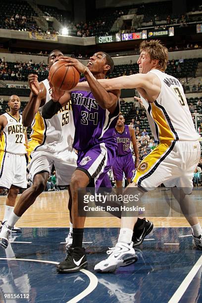 Jason Thompson of the Sacramento Kings battles Troy Murphy and Roy Hibbert of the Indiana Pacers at Conseco Fieldhouse on March 30, 2010 in...