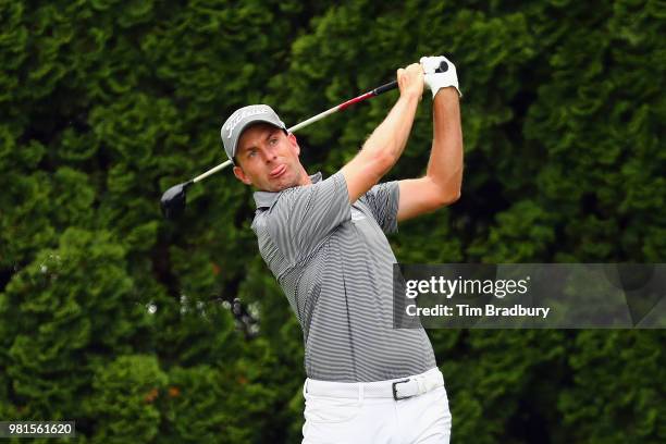 Webb Simpson of the United States plays his shot from the ninth tee during the second round of the Travelers Championship at TPC River Highlands on...