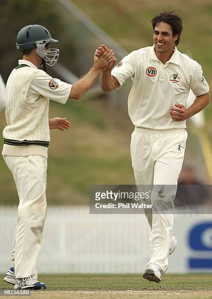 Mitchell Johnson of Australia celebrates his dismissal of Brent Arnel of New Zealand with Simon Katich during day five of the Second Test match...