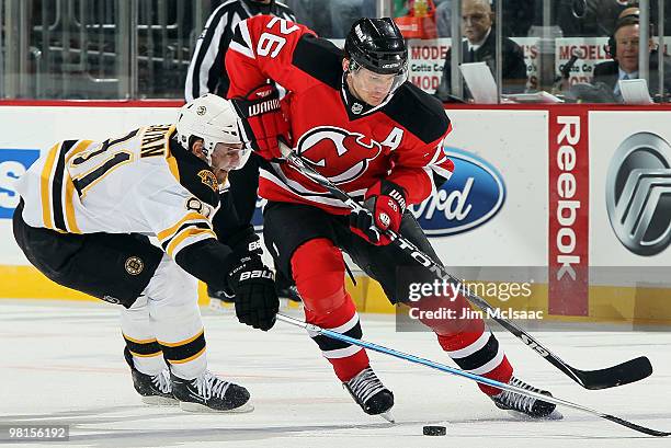 Patrik Elias of the New Jersey Devils carries the puck against Miroslav Satan of the Boston Bruins at the Prudential Center on March 30, 2010 in...