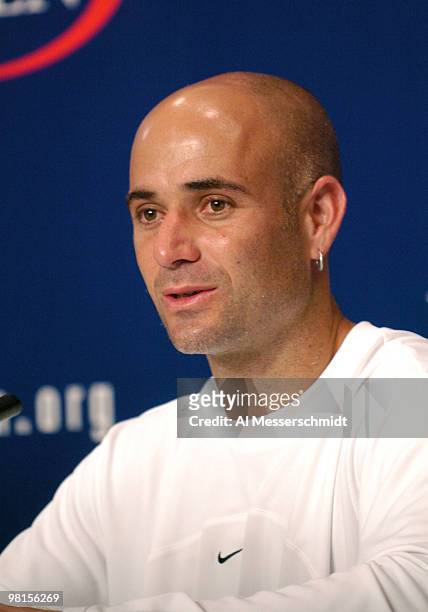Andre Agassi talks to the press after losing to top-seeded Roger Federer in the quarter finals of the men's singles September 9, 2004 at the 2004 US...