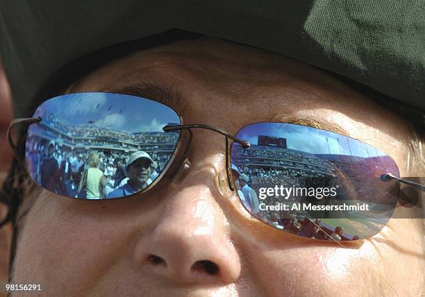 Fan's sunglasses reflect returning blue skies as top-seeded Roger Federer defeats Andre Agassi in the quarter finals of the men's singles September...