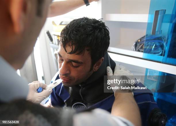 Civil defence personnel provide first aid to Adnan Nassrat after his return from a successful 48-hour long dive on June 22, 2018 in Aqaba, Jordan....