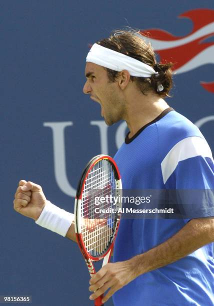 Top-seeded Roger Federer defeats Andre Agassi in the quarter finals of the men's singles September 9, 2004 at the 2004 US Open in New York.
