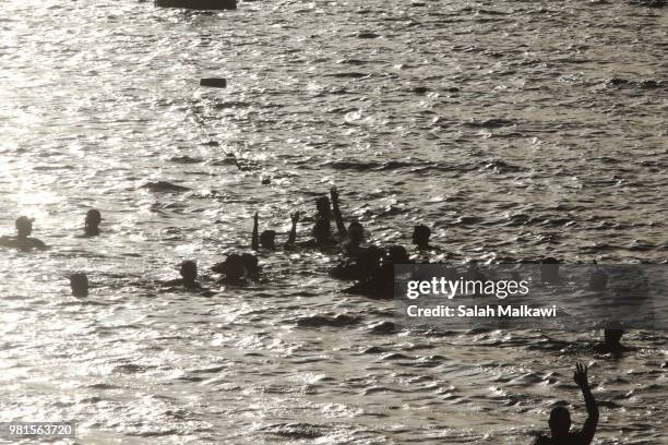 Adnan Nassrat is assisted by a volunteer support team as he returns to land after a successful 48-hour long dive on June 22, 2018 in Aqaba, Jordan....