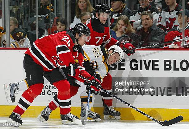 Vladimir Sobotka of the Boston Bruins is sandwiched between Paul Martin and Patrik Elias of the New Jersey Devils during their game at the Prudential...
