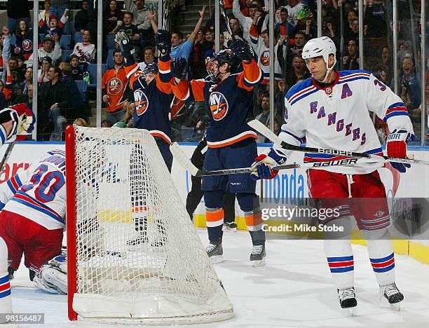 Blake Comeau of the New York Islanders celebrates his first-period goal at 12:09 with teammate Tim Jackman as Michal Rozsival of the New York Rangers...