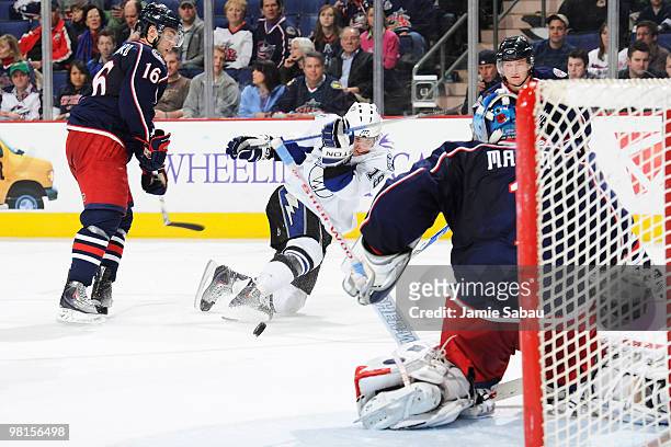Stephane Veilleux of the Tampa Bay Lightning fires off a shot from his knees past Derick Brassard and on to goaltender Steve Mason, both of the...