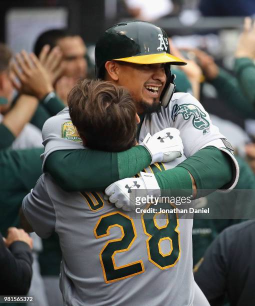 Franklin Barreto of the Oakland Athletics is lifted by teammate Matt Olson after hitting his second three run home run of the game in the 8th inning...