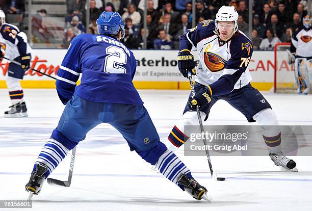 Luke Schenn of the Toronto Maple Leafs defends against Evgeny Artyukhin of the Atlanta Thrashers during game action March 30, 2010 at the Air Canada...