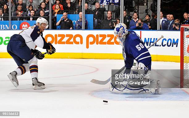 Maxim Afinogenov of the Atlanta Thrashers is topped on a breakaway by Jonas Gustavsson of the Toronto Maple Leafs during game action March 30, 2010...