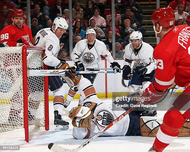 Jeff Deslauriers of the Edmonton Oilers makes a save as teammates Dean Arsene, Aaron Johnson and Ryan Potulny watch the puck along with Tomas...