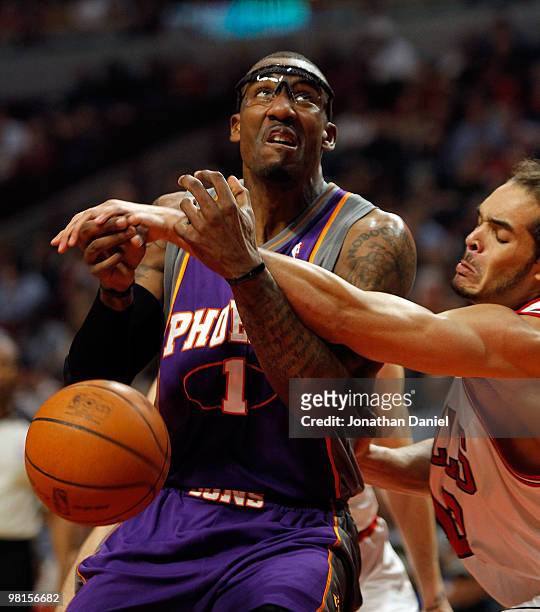 Amar'e Stoudemire of the Phoenix Suns is fouled by Joakim Noah of the Chicago Bulls at the United Center on March 30, 2010 in Chicago, Illinois. NOTE...