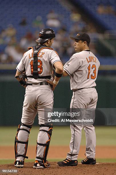 Baltimore Orioles catcher Javy Lopez meets with pitcher Rodrigo Lopez during play against the Tampa Bay Devil Rays July 22, 2006 in St. Petersburg.